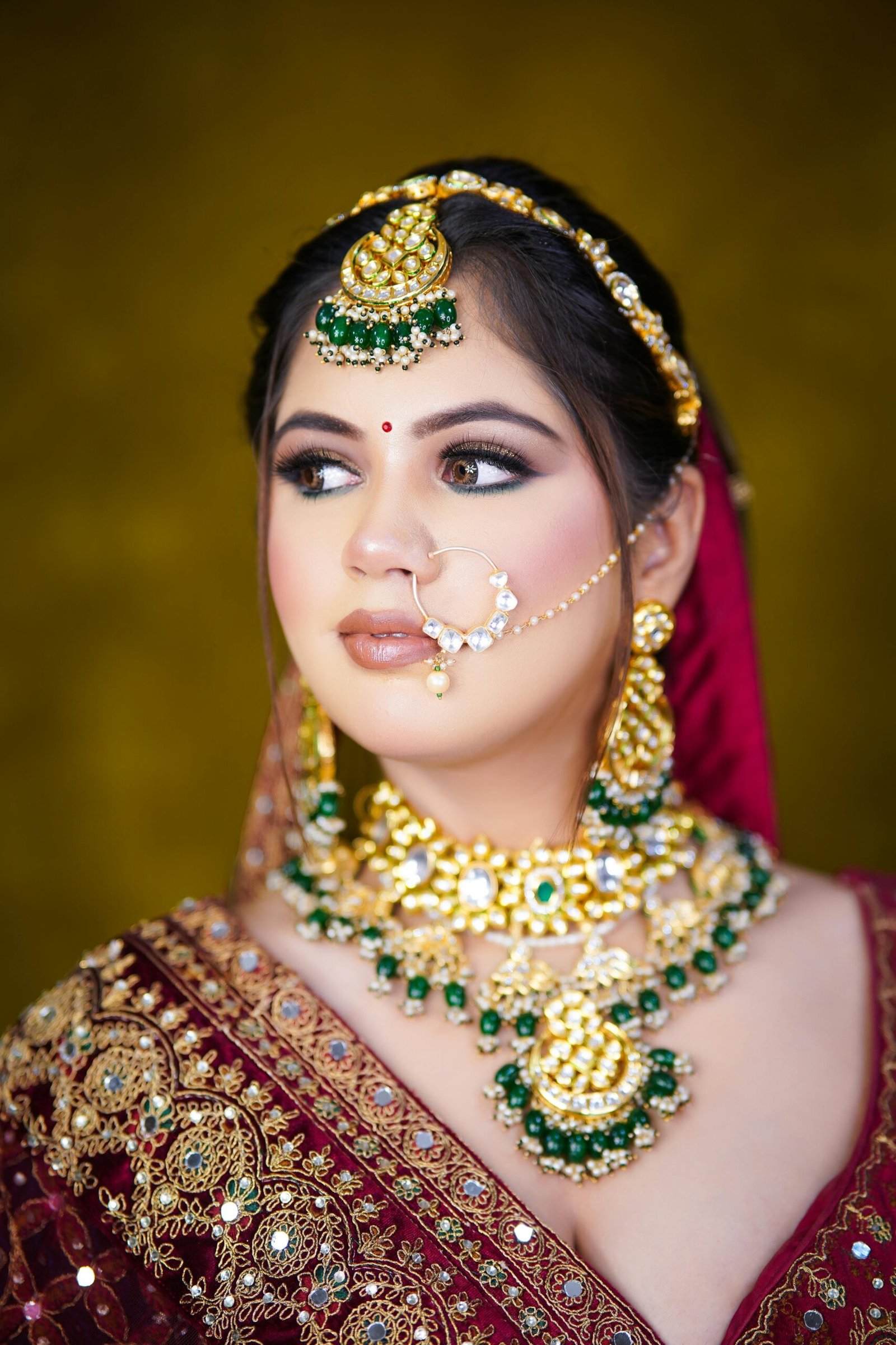 Portrait of an Indian bride in traditional attire and ornate jewelry, exuding elegance and cultural richness.